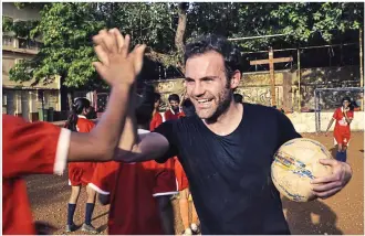  ?? COMMON GOAL/GETTY IMAGES ?? Giving back: Mata plays with children in the Ambedkar Nagar slum in Mumbai, as he heads up his new charity initiative called Common Goal