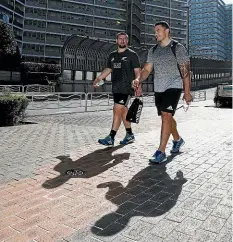  ??  ?? Dane Coles, left, and Codie Taylor return to the team bus after a training session in Tokyo this week.