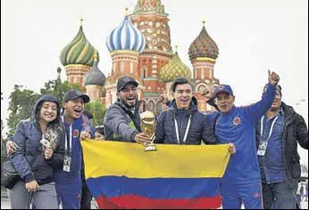  ?? AFP ?? Colombian fans with a trophy replica in front of Saint Basil's Cathedral on the Red Square, Moscow.