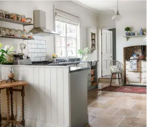  ??  ?? KITCHEN
A boarded half-wall and stone floor add to the country feel. Aga range cooker, price on request, Aga Living. Spiral leg table, £50, Bishopgate Antiques. Try Grand Paris pendant light, £85, Garden Trading