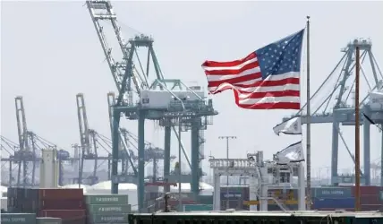  ?? — Reuters ?? A US flag flies at the Port of Los Angeles in Los Angeles, California.