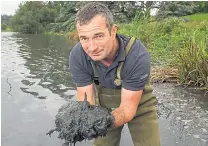  ??  ?? A member of the Blenheim Palace team with a handful of silt that is a threat to the lakes and the iconic bridge. Right, work to create the lakes in the 1760s
