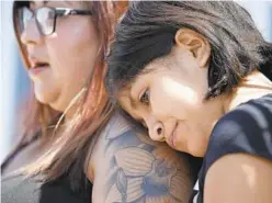  ?? JOHN LOCHER/AP ?? Eleven-year-old Leilani Hebben puts her head on her mother Anabel Hebben's shoulder Sunday as they visit the scene of a mass shooting in El Paso, Texas.