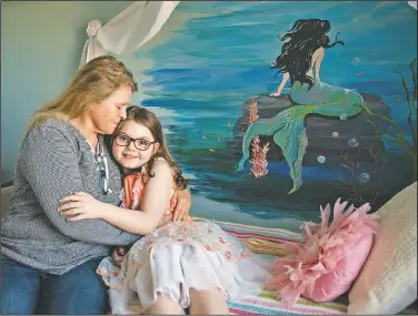  ??  ?? Mary Jane poses with her grandmothe­r Linda Soli at her home. “My favorite thing is the mermaid picture on the wall because it’s a mermaid and I love it,” Mary Jane said. “It’s shiny and bright.”