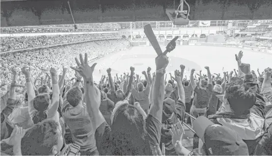  ?? Steve Gonzales / Houston Chronicle ?? Astros fans erupt after Jose Altuve drives in two runs in the bottom of the fifth inning against the Yankees. The Astros tied the ALCS series at 3-3.