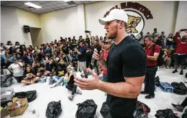  ?? Brett Coomer / Houston Chronicle ?? Texans defensive end J.J. Watt talks to volunteers Sept. 3 while distributi­ng relief supplies to people in the Houston area impacted by Hurricane Harvey.