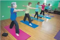  ??  ?? Members take part in “Grandma Yoga” class.