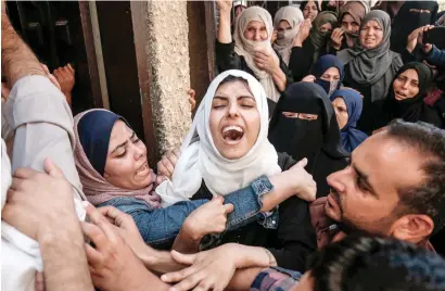  ?? AFP ?? Mariam, the sister of slain Palestinia­n Mohamed Abu daqa, cries during his funeral in Khan yunis in the southern gaza strip on saturday. Abu daqa was one of three Hamas members killed during Israeli bombardmen­t of gaza on friday. —