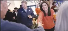  ?? AP photo ?? Republican presidenti­al candidate former UN Ambassador Nikki Haley shakes hands with a patron during a campaign stop at a restaurant on Monday, in Concord, N.H. At left is N.H. Gov. Chris Sununu.