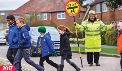  ??  ?? Career path: Mrs Cattle is still helping pupils cross the road almost half a century after she began