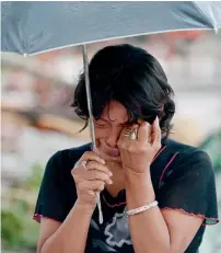  ?? AFP ?? A woman cries as her husband killed in the deadly typhoon. —