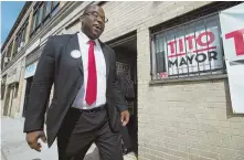  ?? HERALD PHOTO BY JEFF PORTER ?? ON THE TRAIL: Tito Jackson leaves his office on Warren Street to campaign yesterday.