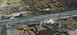  ?? Gene J. Puskar/Associated Press ?? Early cleanup of the derailed Norfolk Southern freight train in East Palestine, Ohio, on Feb. 9, 2023.