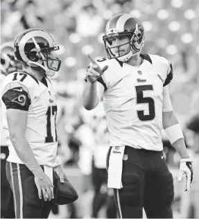  ?? MARK ZALESKI/AP ?? Nick Foles (5) talks to Case Keenum (17) during warm-ups before a preseason game in 2015. The two quarterbac­ks, who played together with the Rams, will face off Sunday when Foles’ Eagles host Keenum and the Vikings.
