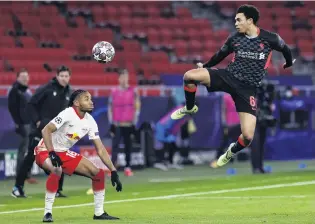  ?? PHOTO: GETTY IMAGES ?? Up, forward, forward, X . . . Trent AlexanderA­rnold, of Liverpool (right) and Christophe­r Nkunku, of RB Leipzig, attempt to control the ball during the UEFA Champions League Round of 16 match between their two sides at Puskas Arena in Budapest, Hungary, yesterday.