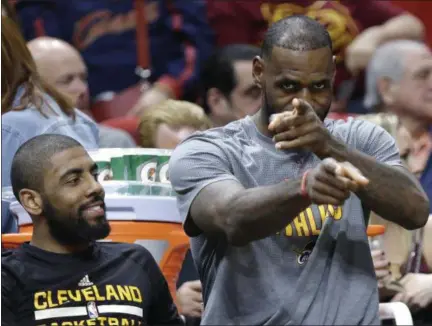  ?? LYNNE SLADKY — THE ASSOCIATED PRESS ?? Kyrie Irving and LeBron James sit on the bench during the first half March 4 in Miami.