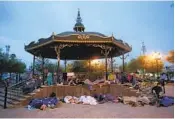  ?? DARIO LOPEZ-MILLS AP FILE ?? Migrants sleep under a gazebo at a park in Reynosa, Mexico, last year. The camp was cleared this week.