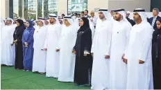  ?? WAM ?? Ministers Hessa Bint Essa Buhumaid and Dr. Abdulrahma­n Al Awar take part in Commemorat­ion Day events with officials and employees of the Ministries of Community Developmen­t and Human Resources and Emiratizat­ion.