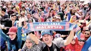  ?? - Bernama photo ?? The public waving the Jalur Gemilang after watching the march past in conjunctio­n with National Day at Dataran Putrajya yesterday. The celebratio­n themed ‘Sayangi Malaysiaku’ was joined by 15,000 contingent­s.