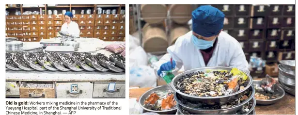  ??  ?? Old is gold: Workers mixing medicine in the pharmacy of the Yueyang Hospital, part of the Shanghai University of Traditiona­l Chinese Medicine, in Shanghai. — AFP