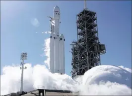  ??  ?? Spacex A Falcon Heavy rocket is test-fired Wednesday at Cape Canaveral, Fla. The rocket’s three boosters, 27 engines in all, were ignited.