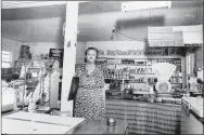  ??  ?? Ruth Leach stands inside the R.L. Leach Grocery Store in the 1960s in Dutch Mills. The local post office was located inside the store and Leach served as post master for 39 years.