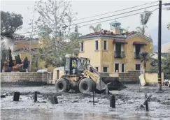  ??  ?? Work begins to clear debris after the midslides in Montecito