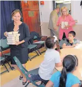  ?? JIM THOMPSON/JOURNAL ?? Jennifer Ramo, left, and then-Bernalillo County Commission­er Maggie Hart Stebbins pass out dinners to kids in the After School Meals Program at Barelas Community Center in 2014.