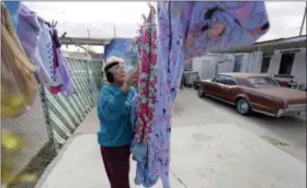  ?? ERIC GAY — THE ASSOCIATED PRESS ?? Mickie Subia gathers her laundry at her home in El Paso, Texas, last month. Subia lives less than a block away from a border barrier that runs along the Texas-Mexico border in El Paso.