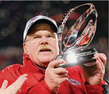  ?? Kevin C. Cox/TNS ?? Coach Andy Reid of the Kansas City Chiefs holds up the Lamar Hunt Trophy after defeating the Cincinnati Bengals in the AFC Championsh­ip Game at GEHA Field at Arrowhead Stadium on Sunday in Kansas City, Mo.