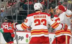  ?? Bruce Bennett / Getty Images ?? Calgary’s Milan Lucic, right, celebrates his first-period goal with teammate Sean Monahan against the Devils on Tuesday.