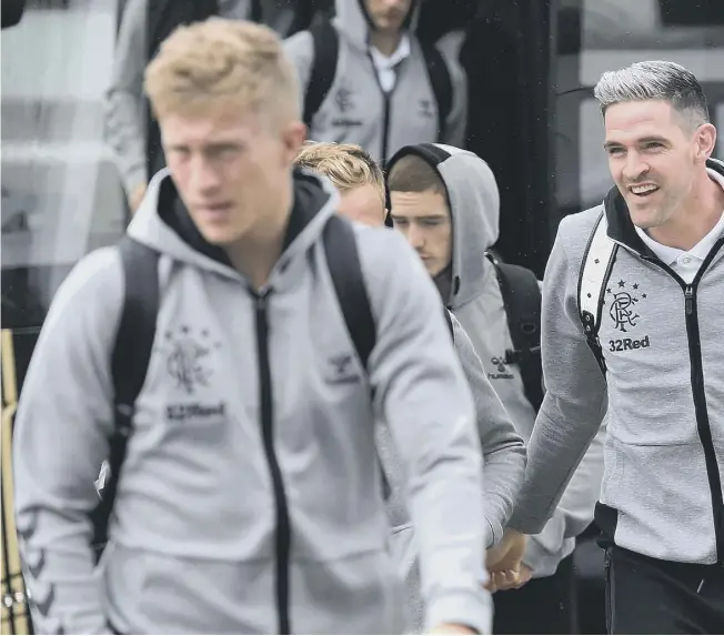  ??  ?? 0 Grey day: Kyle Lafferty, right, was sporting a new hairstyle as the Rangers squad departed for Spain yesterday. They face Villarreal this evening in their opening group match in the Europa League.