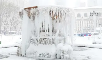  ??  ?? The frozen Josephine Shaw Lowell Memorial Fountain in Bryant Park is seen during a winter storm in New York City.