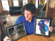  ?? MARY ESCH / ASSOCIATED PRESS ?? Denise Krohn at her kitchen table with photos of her dogs, which were shot dead during a burglary a year ago at her home in rural upstate New York. Krohn is pushing for a law named after the pets.