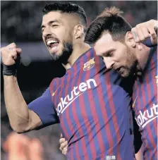  ??  ?? Barcelona’s Lionel Messi, right and Barcelona’s Luis Suarez celebrate after Messi had scored his side’s third goal during the Champions League match between FC Barcelona and Olympique Lyon at the Camp Nou stadium in Barcelona, Spain, last night.