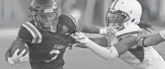  ?? ARIA ALA-U-DINI / THISWEEK ?? Harvest Prep’s Artrell Saunders, right, tackles Bishop Hartley’s Richard Kenny on Friday.