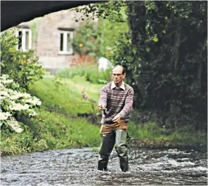  ??  ?? Crickhowel­l fly fishing near his home on a tributary of the River Usk: after retiring from the Commons he served as chairman of the National Rivers Authority