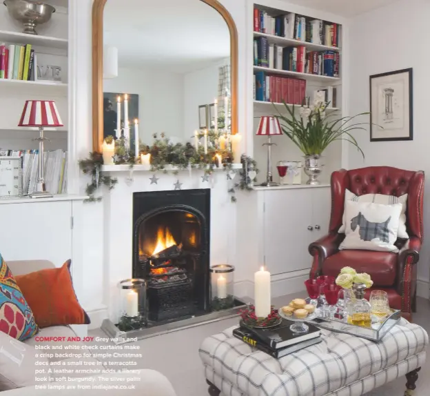  ??  ?? COMFORT AND JOY Grey walls and black and white check curtains make a crisp backdrop for simple Christmas decs and a small tree in a terracotta pot. A leather armchair adds a library look in soft burgundy. The silver palm tree lamps are from...