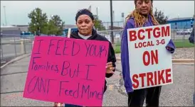  ?? Alyssa Keown / Associated Press ?? Cherri Crockett and Towanna Toliver join other union members in Battle Creek, Mich., in a strike against Kellogg. Workers across the country walked out at 1 a.m. Tuesday, demanding better wages and benefits.