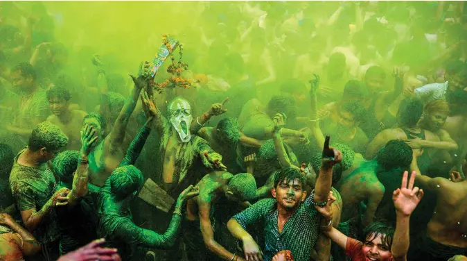  ??  ?? Revelers dance as they celebrate Holi, the spring festival of colors, in Allahabad on March 10, 2020. — AFP