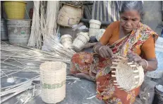  ?? — AFP file photo ?? Labourer Lakshmi, 65, weaves a bamboo basket at a workshop in Chennai on February 23, 2017. Labourers at the workshop earn some Rs 200 per day making and selling bamboo products.