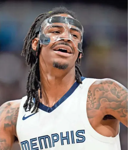  ?? DAVID ZALUBOWSKI/AP ?? Grizzlies guard Ja Morant looks to the bench during a game against Denver on March 3.