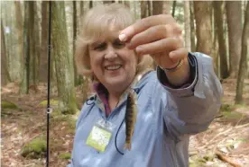  ?? | DALE BOWMAN/ FOR THE SUN- TIMES ?? Janet Elbalghiti shows off her first native brook trout the spring before she began battling cancer. Elbalghiti ( shortly before her death last summer) with dad Leroy Bowman on a hike at Patuxent Research Refuge.