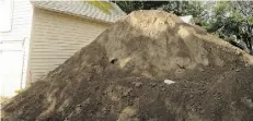  ?? SUPPLIED ?? During infill constructi­on last summer, dirt was piled against a 1906 stable Brian Gregg uses as a shed, bowing in a wall.