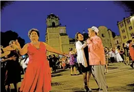  ??  ?? Dancing to music by Marimba del Gobierno de Estado de Oaxaca, in the zócalo, a nightly entertainm­ent spot in the heart of the city.