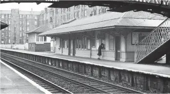  ?? Norris Forrest/Transport Treasury ?? Merchiston station was just 1¼ miles out from Edinburgh (Princes Street) and was served by trains on the short-service to Kingsknowe, a limited number of Carstairs/Lanark duties, as well as most travelling to/from Glasgow via the Shotts route, a good number of these being diesel-multiple-unit worked by this time. A passenger is seen purchasing a ticket on the up (Carstairs/Shotts bound) platform, its signal box being an 1898 addition to the July 1882 premises, albeit inactive post-1960 once the domain of Dalry Junction signal box was extended. A victim of being the wrong side of Slateford Junction, this station was doomed with the eradicatio­n of the Princes Street terminus.