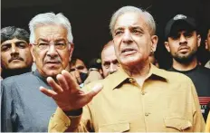  ?? AFP ?? Shahbaz Sharif (right), brother of Nawaz Sharif, talks with media representa­tives as he leaves the High court in Lahore yesterday.