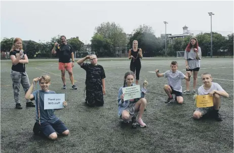  ??  ?? POWERING THROUGH Priory School headteache­r, Stewart Vaughan, along with pastoral outreach worker, Katherine Hughes, and the key worker children who took part in the run. Below, the medals donated by Victory Trophies