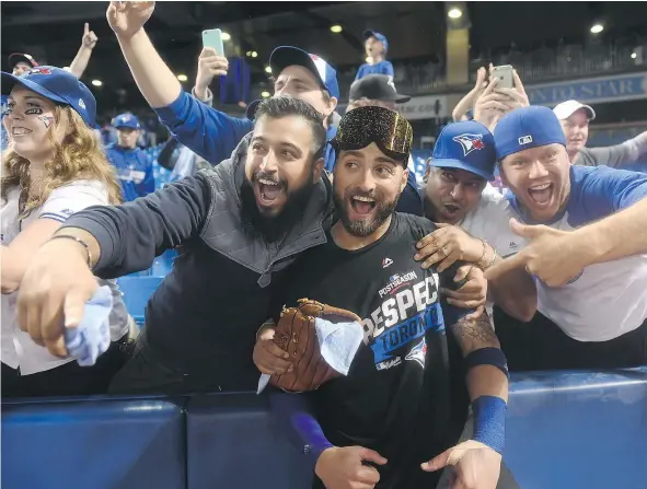 ?? — THE CANADIAN PRESS FILES ?? Kevin Pillar celebrated with fans after the Toronto Blue Jays beat the Texas Rangers 7-6 in Game 3 of the American League Division Series in Toronto on Sunday. The Blue Jays will enjoy some much-needed rest before the next series begins Friday.