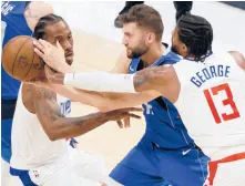  ?? MICHAEL AINSWORTH/AP ?? Clippers forward Kawhi Leonard, left, and guard Paul George (13) pressure Mavs center Dwight Powell during Game 6 on Friday in Dallas.